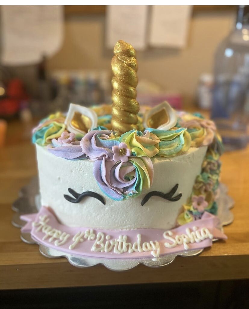 A two-tier cake finished with colorful buttercream flowers