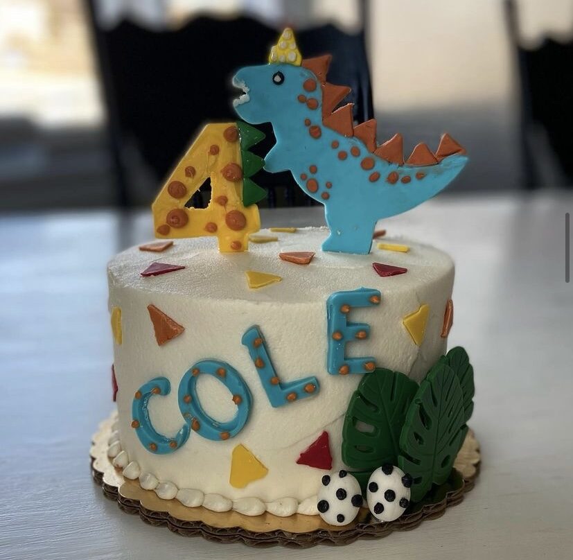 A tall novelty cake decorated for a child's celebration