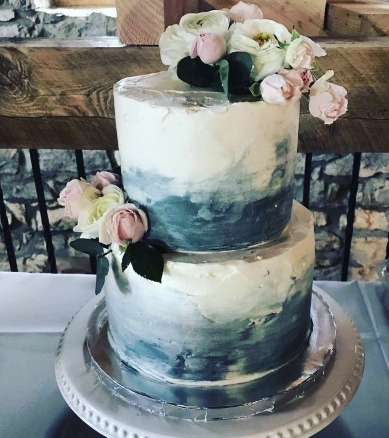An elegant white celebration cake finished with fresh berries